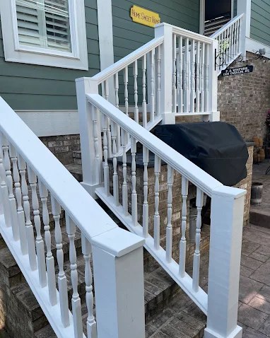 Crisp white painted exterior stair railings and turned balusters